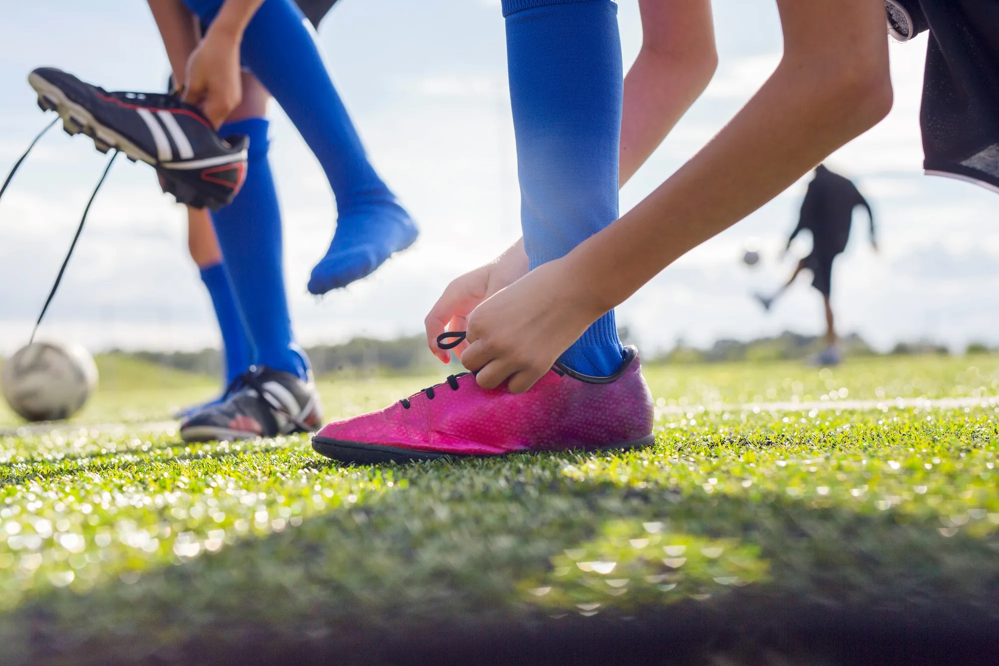 Boy tying soccer shoe